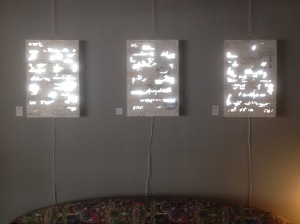 Susana's artwork; words and sentences laser cut and molded in plaster into boards and mirrors, lit from behind, based on conversations about relationships.